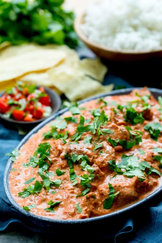 Crockpot butter chicken in a blue dish