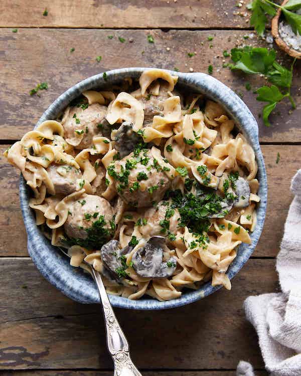 Meatballs Stroganoff served in a bowl over a brown table