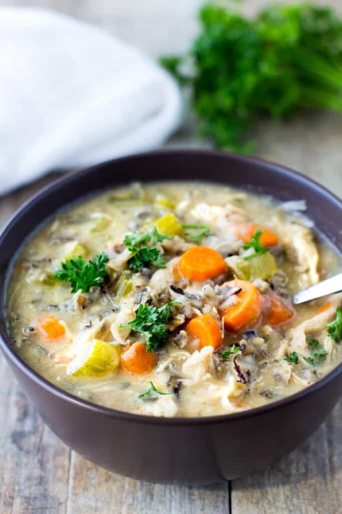 Creamy Chicken and Wild Rice Soup Slow Cooker in a black bowl