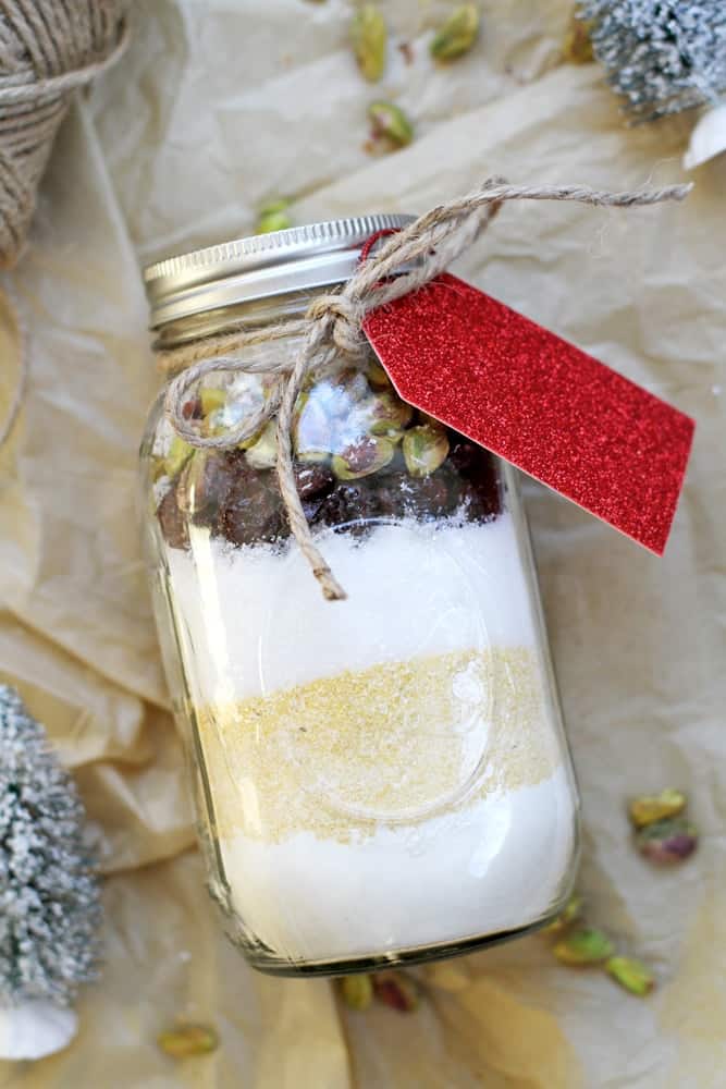 Cherry Coconut-Pistachio Biscotti Gift Jar on a craft paper with a red tag