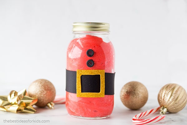 Fluffy Santa in a Jar next to decorated golden balls