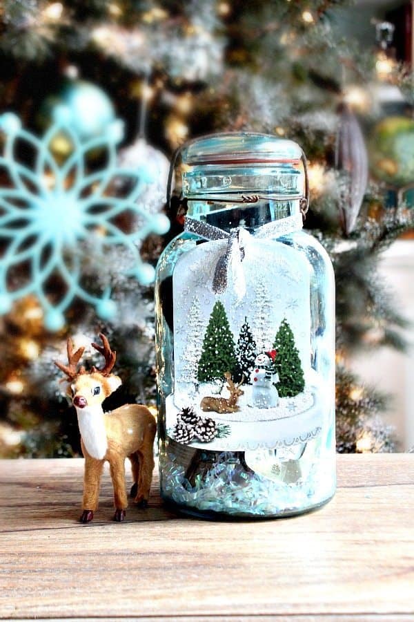 Mason Jar Christmas Gift Idea placed on a wooden table next to a reindeer
