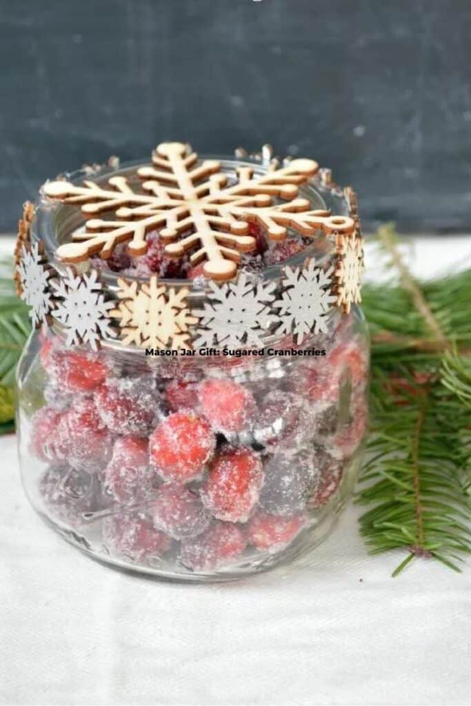 Mason Jar Gift Sugared Cranberries Next to Green Leaves on the Table