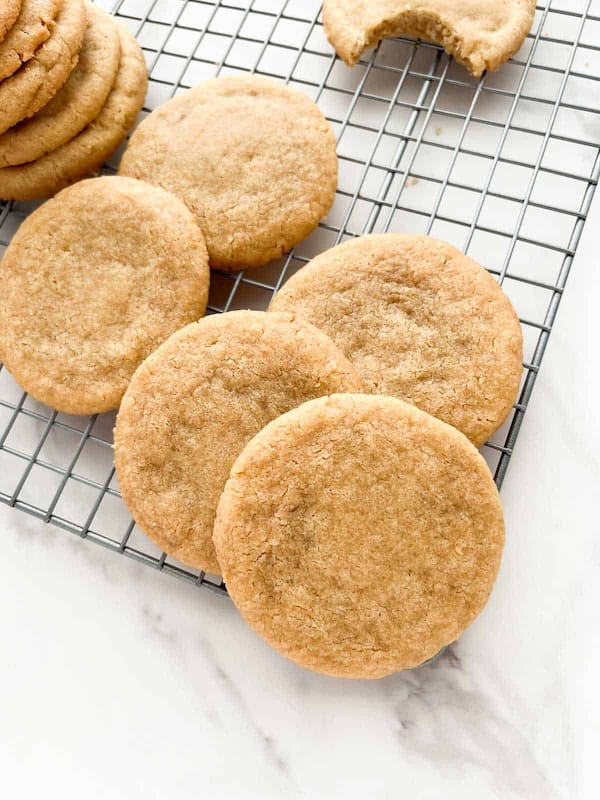 Simple brown sugar cookies made with butter and flour, lightly golden and stacked for a holiday cookie assortment — easy Christmas cookie recipes.
