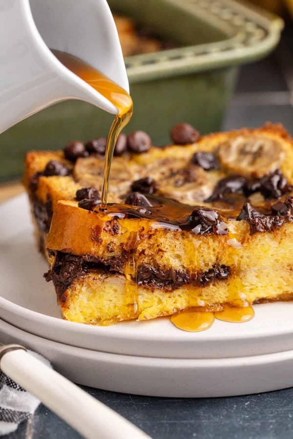 Banana French toast casserole layered with chocolate chips and baked golden — an overnight breakfast bake for Christmas morning.