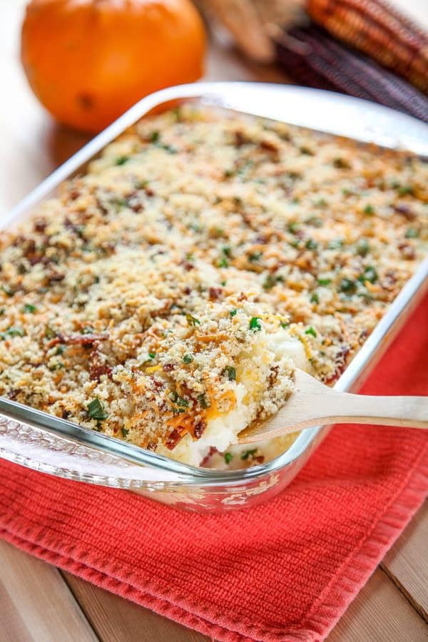 Baked cheesy mashed potato casserole with bacon and melted cheddar — comforting Christmas dinner side dish