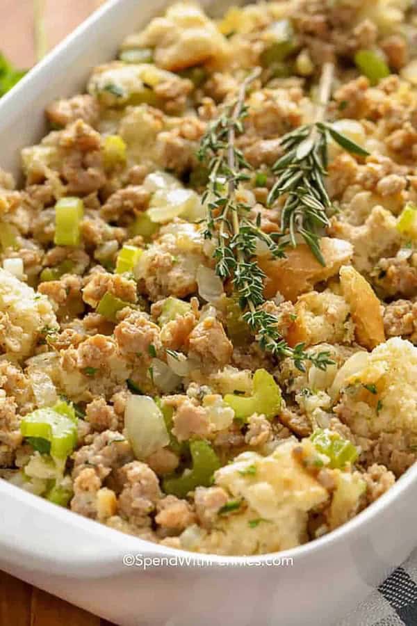 Savory sausage stuffing with bread cubes, onion, and herbs served in a holiday casserole — hearty Christmas side dish recipe.