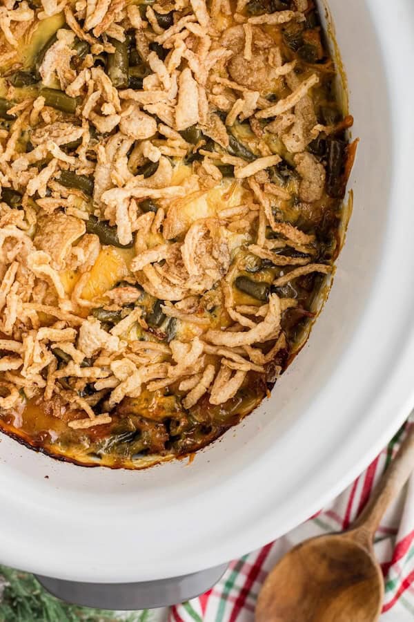 Slow cooker Christmas casserole with ham, potatoes, green beans and melted cheese in a crockpot — a make-ahead Christmas dinner casserole.