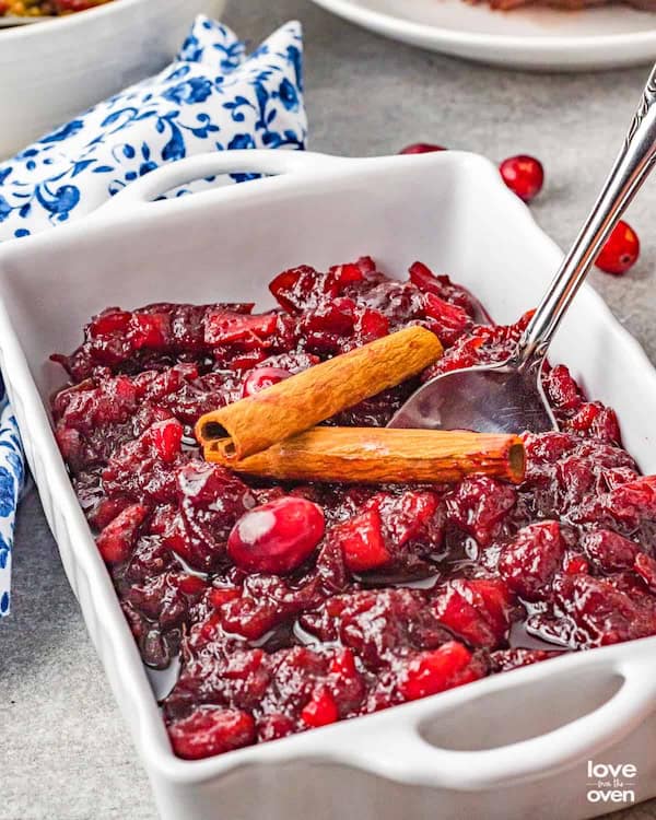 Bowl of apple cranberry sauce with diced apples, whole cranberries and cinnamon — a bright easy Christmas side dish.