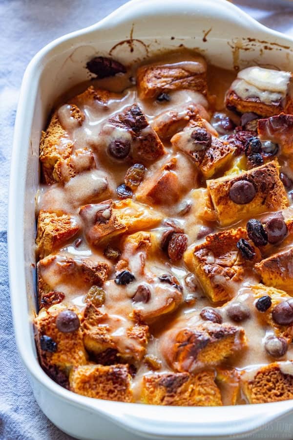 Brioche bread pudding with chocolate chips and raisins in a baking dish — an easy make-ahead Christmas breakfast or brunch bake.