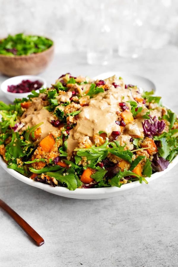 Colorful butternut squash quinoa salad with cranberries and spinach — healthy Christmas side dish idea.