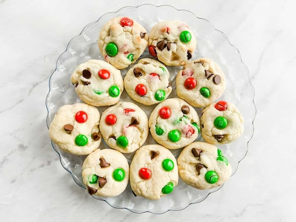 Bright holiday cookies made from cake mix, M&Ms and chocolate chips, arranged on a plate for an easy Christmas cookie treat.