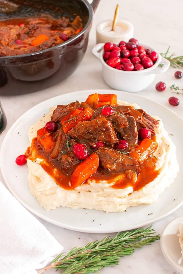 Roast beef in a cranberry-balsamic sauce with carrots and cranberries for a Christmas dinner.