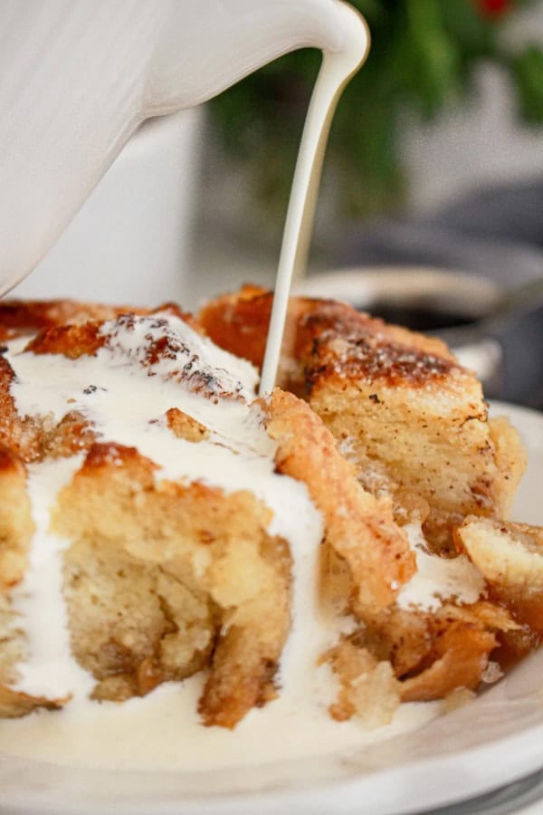 Slice of caramel-topped crème brûlée French toast casserole on a plate with fork — a make-ahead Christmas breakfast bake.