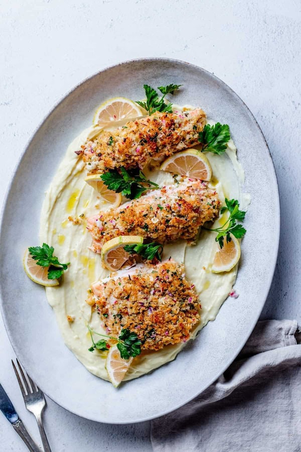 Salmon fillet topped with a golden horseradish crust and served for a Christmas dinner.
