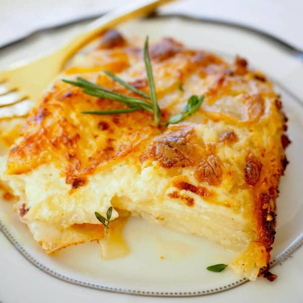 Creamy scalloped potato gratin layered with cheese and herbs — classic Christmas side dish casserole.