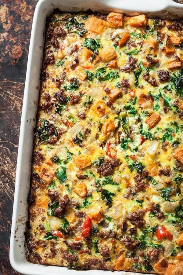 Sweet potato sausage breakfast casserole with kale and peppers in a casserole dish — a make-ahead Christmas morning casserole.