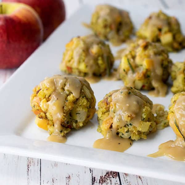 Apple Stuffing Bites with Rosemary Gravy

Turn leftover stuffing into cute bite-size appetizers with this clever recipe. Each savory bite is drizzled with a warm rosemary gravy that makes your holiday party food extra cozy and comforting. It’s a creative way to use classic flavors in a new festive form.
