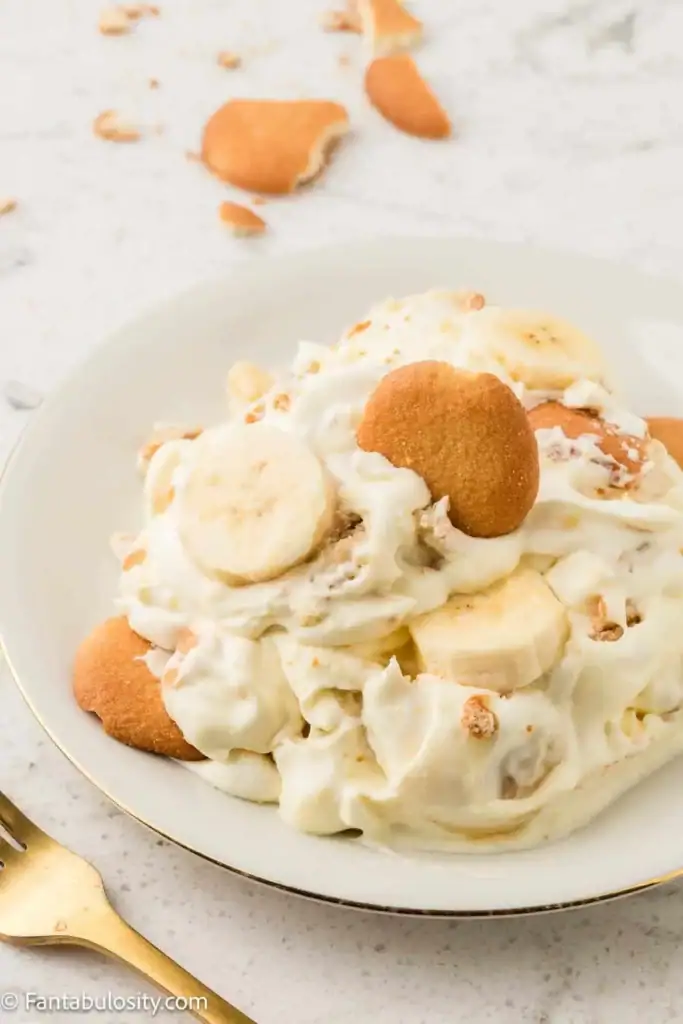 Banana pudding layered with vanilla wafers and sliced bananas in a glass dish