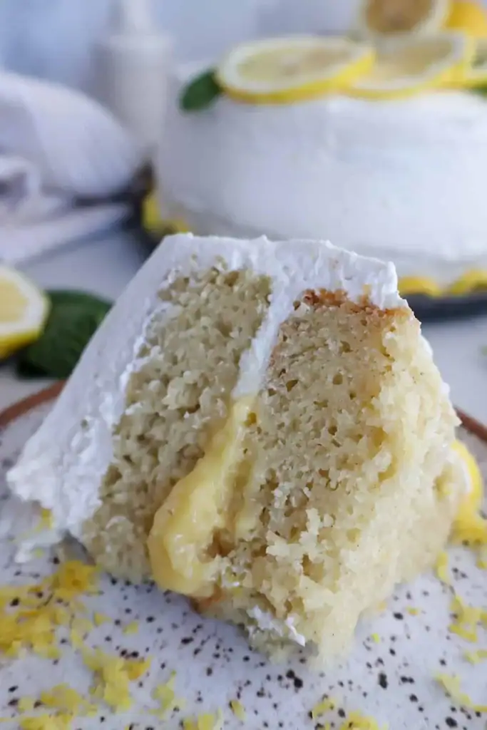 Lemon curd cake with soft layers and bright citrus filling on a serving plate