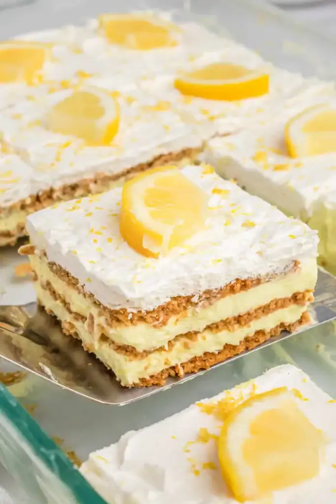 Lemon lush dessert with creamy layers and crumb crust in a glass dish