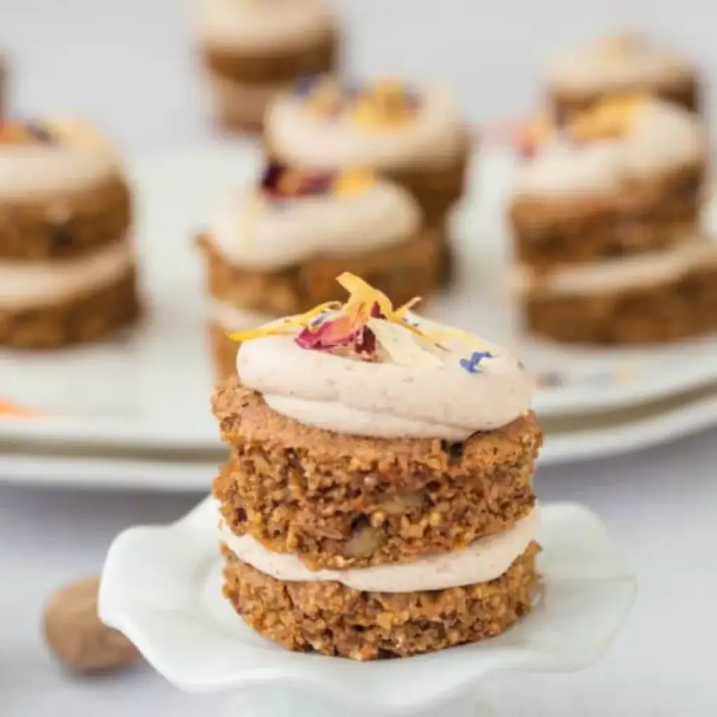 Mini carrot cakes with cream cheese frosting decorated in small individual portions
