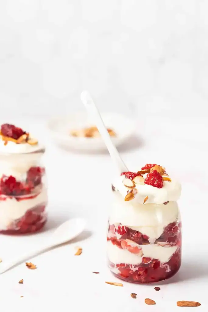 Almond raspberry ricotta parfaits layered in glass cups with fresh berries